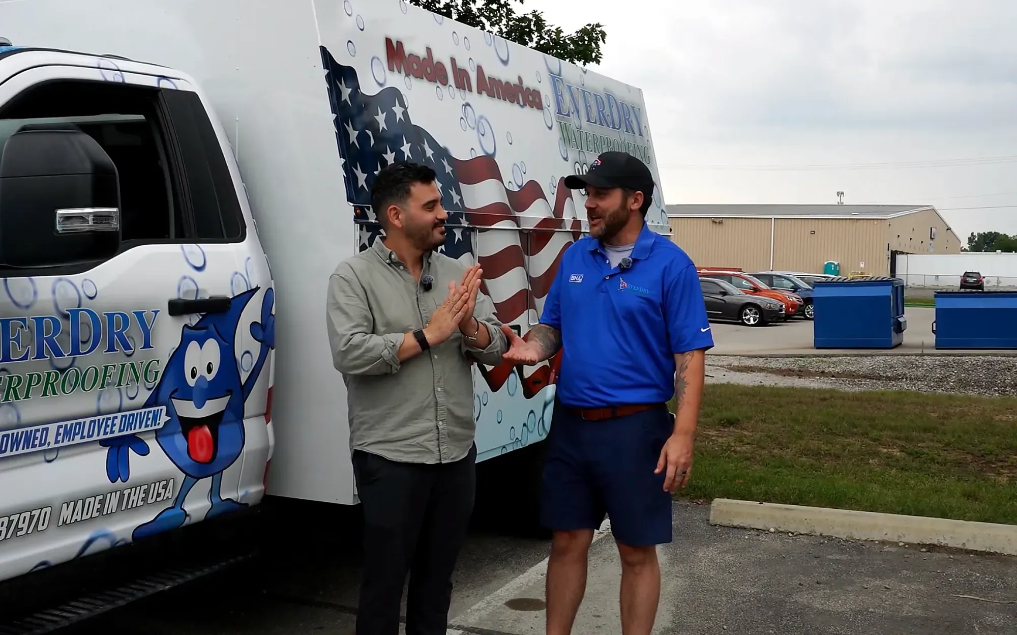 Alejo Ruffino on location with an EverDry crew member beside their branded work truck